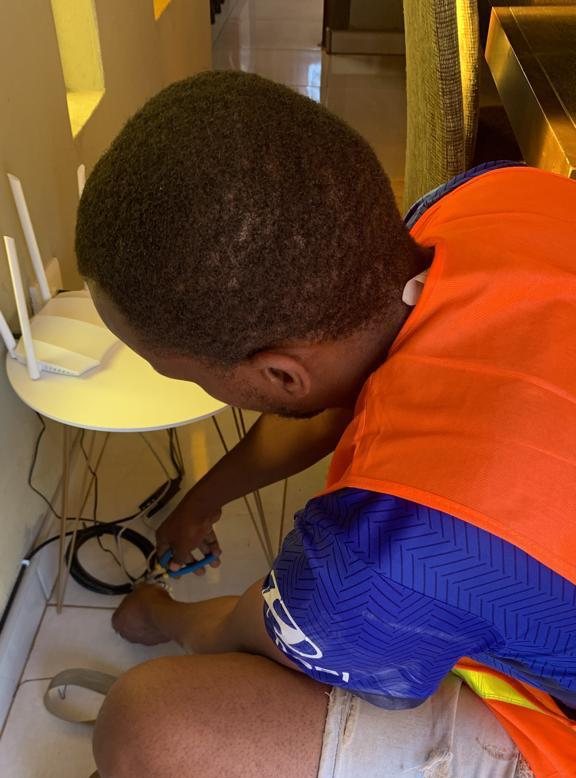 IT Guy Solutions technician connecting a wireless router during an on-site visit