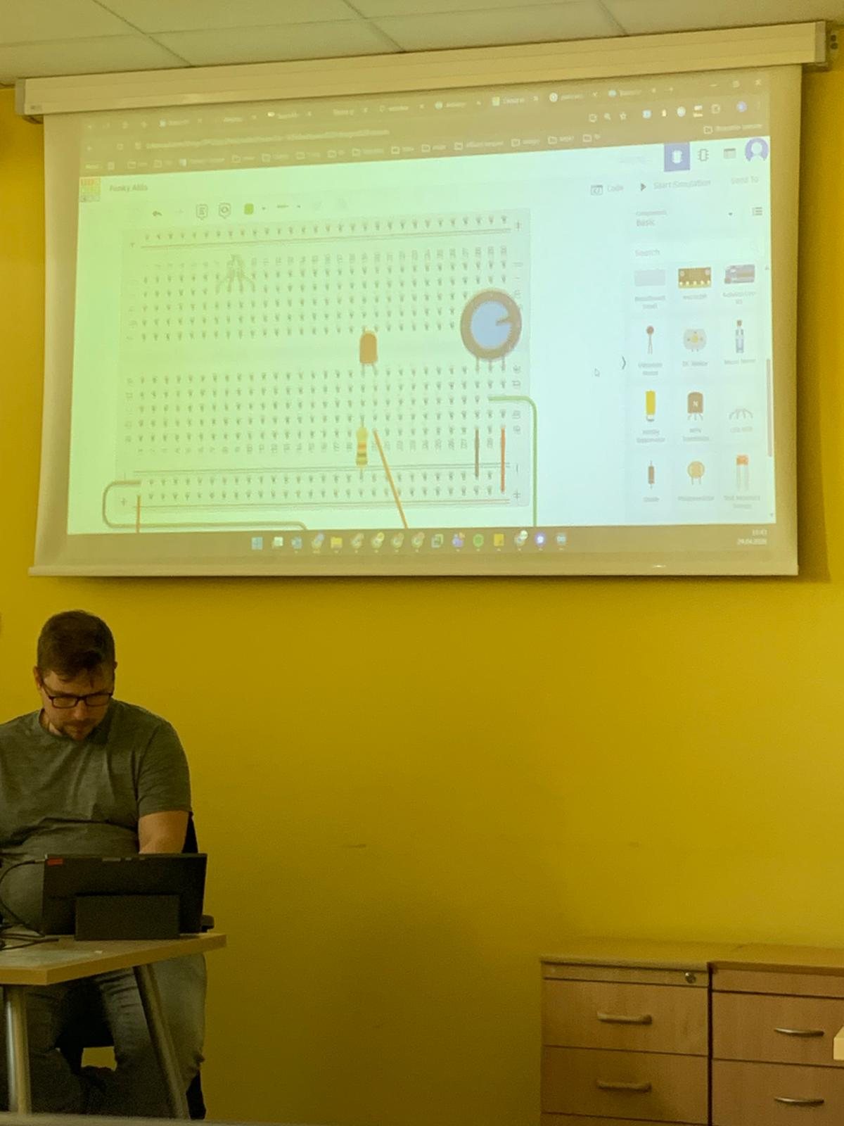 Corporate IT training session with a circuit diagram projected for attendees