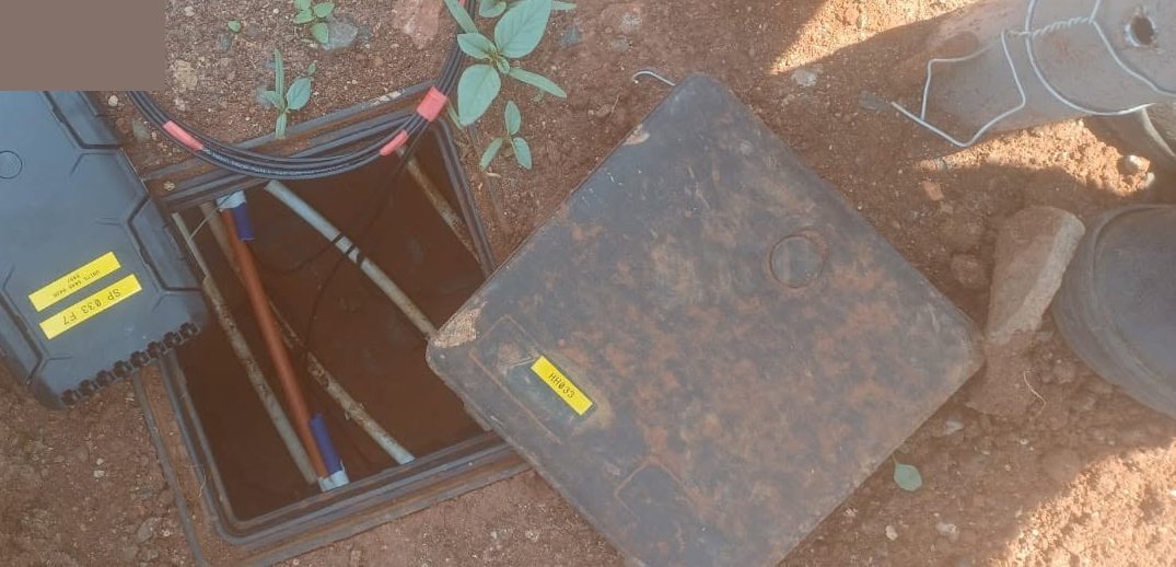 Open telecommunications manhole with a fibre splice closure and ducts during an IT Guy Solutions installation