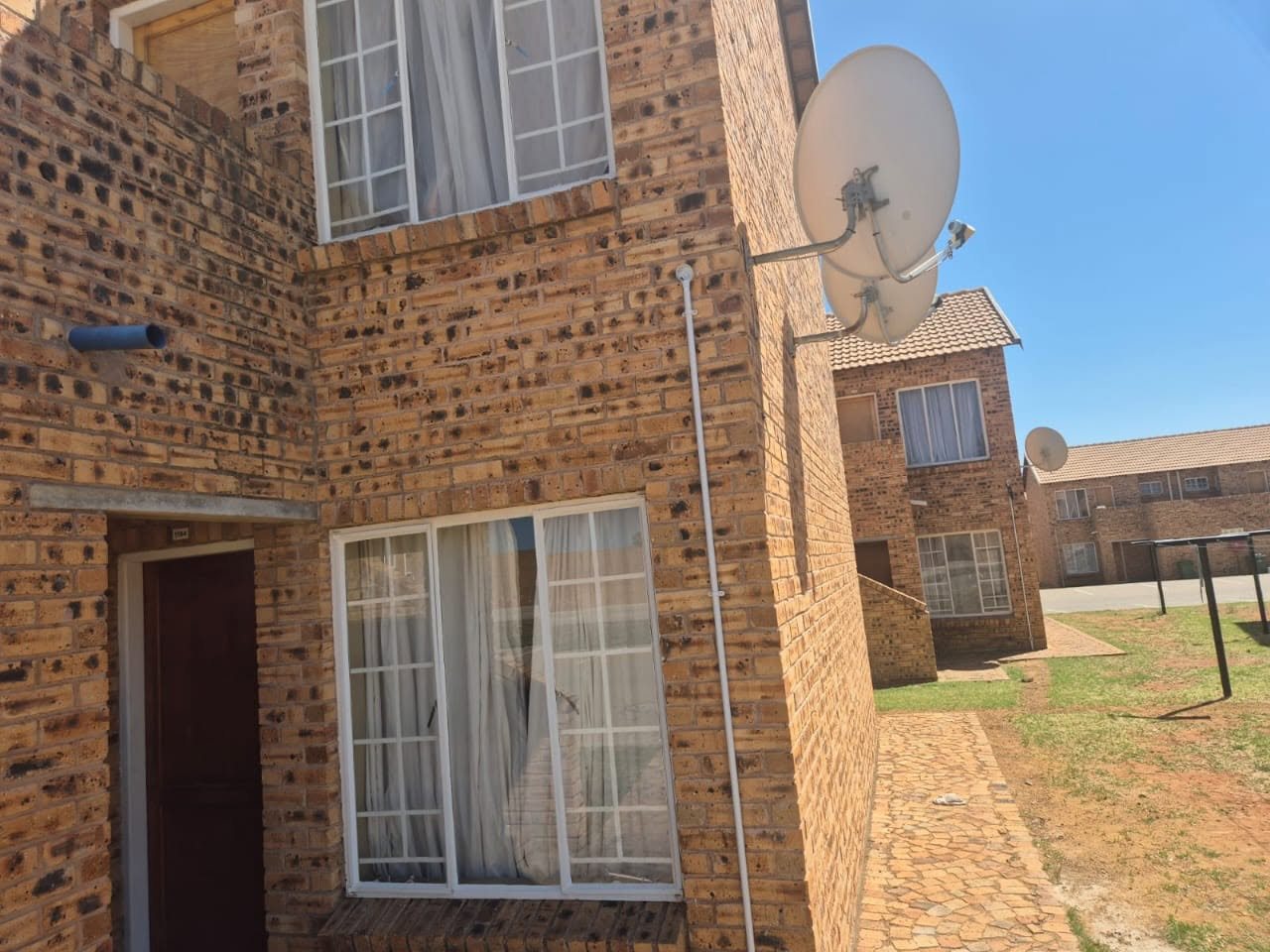 Satellite dishes mounted on a brick residential block during an IT Guy Solutions install
