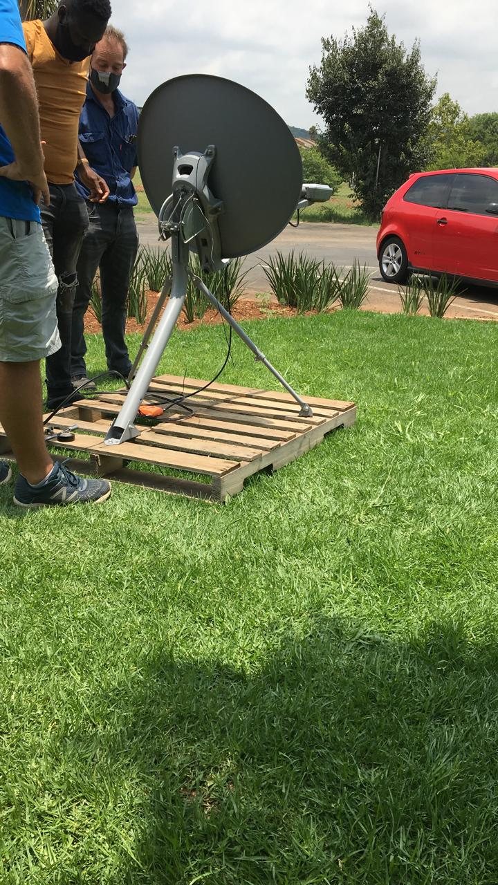 IT Guy Solutions technicians installing and aligning a VSAT dish on a ground mount