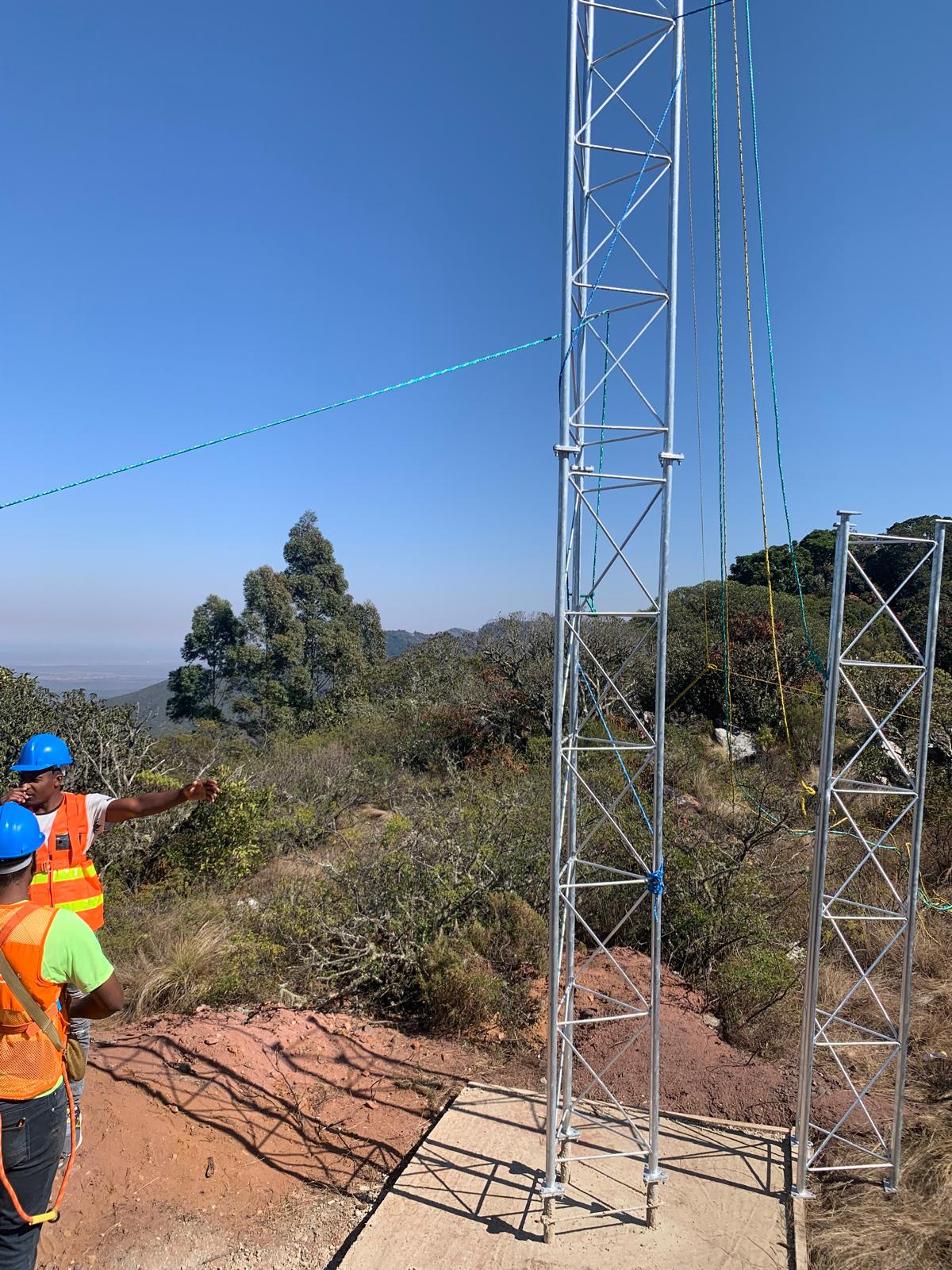 IT Guy Solutions crew assembling a lattice wireless tower on a Limpopo hillside