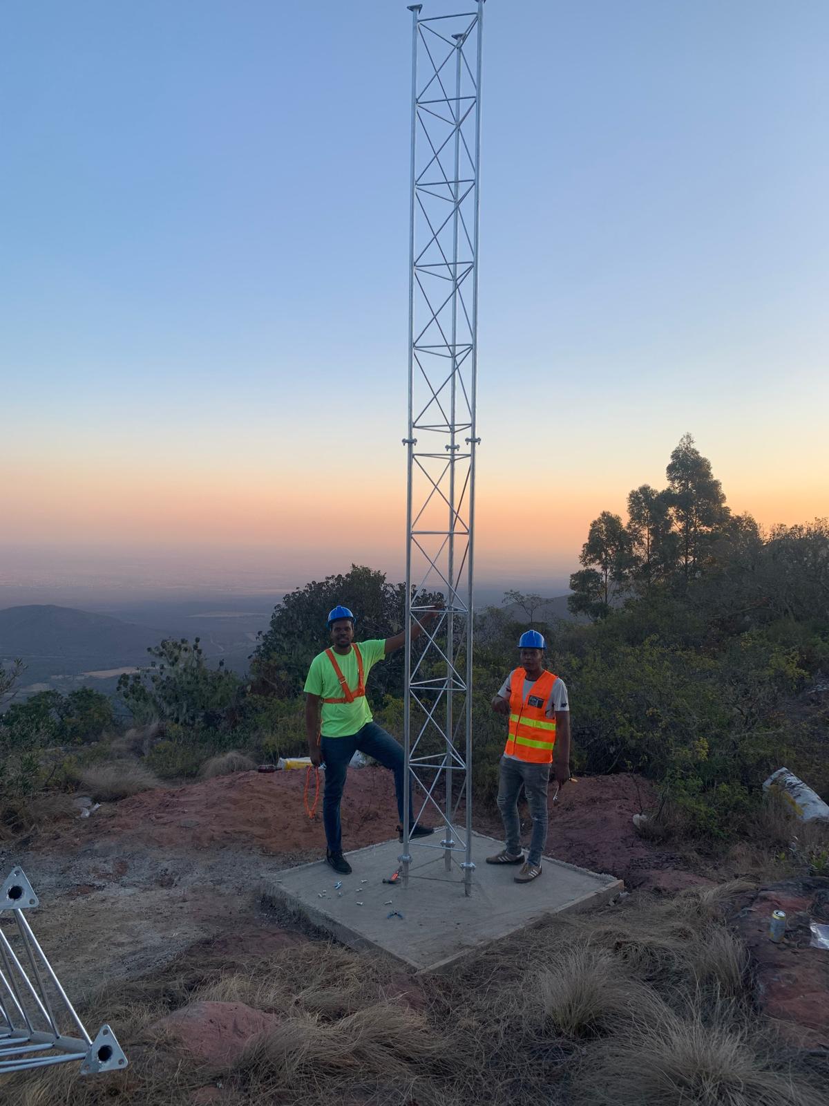 Completed lattice wireless tower on a South African hilltop at sunset
